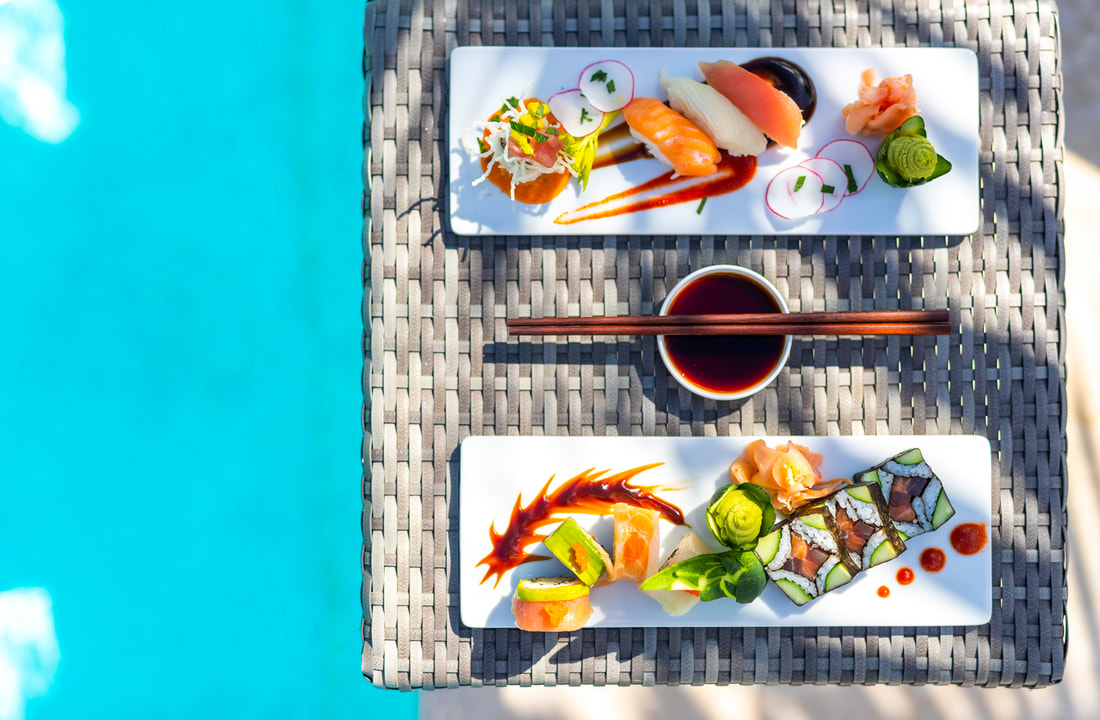 a plate of sushi on the edge of a pool