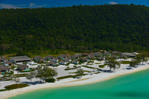 an aerial shot of the hotel on a beach