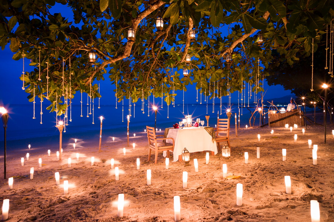 A table on a beach surrounded by lights