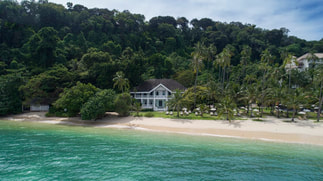 Looking at buildings of Cape Panwa surrounded by forest and on the beachfront