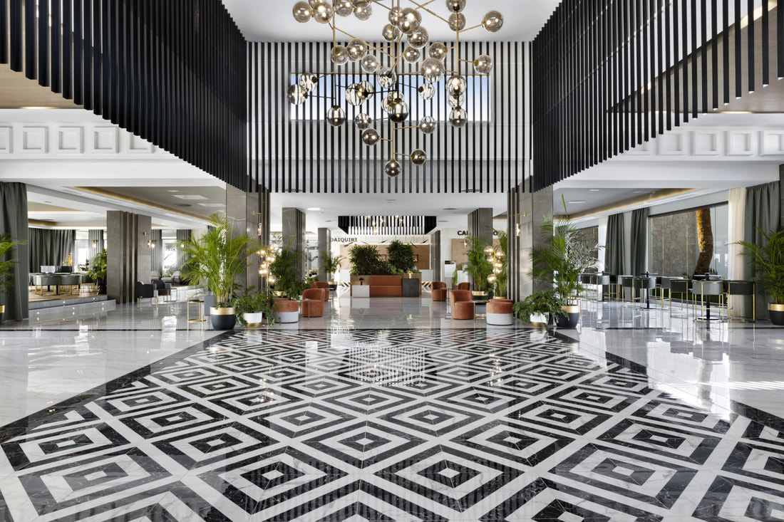 A modern designed lobby with black and white geometric patterns at Hotel Riu Santa Maria