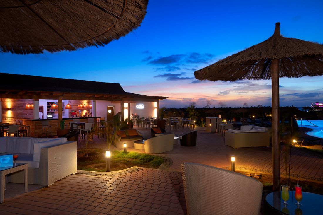 An outdoor bar at dusk at the Melia Llana Beach Resort