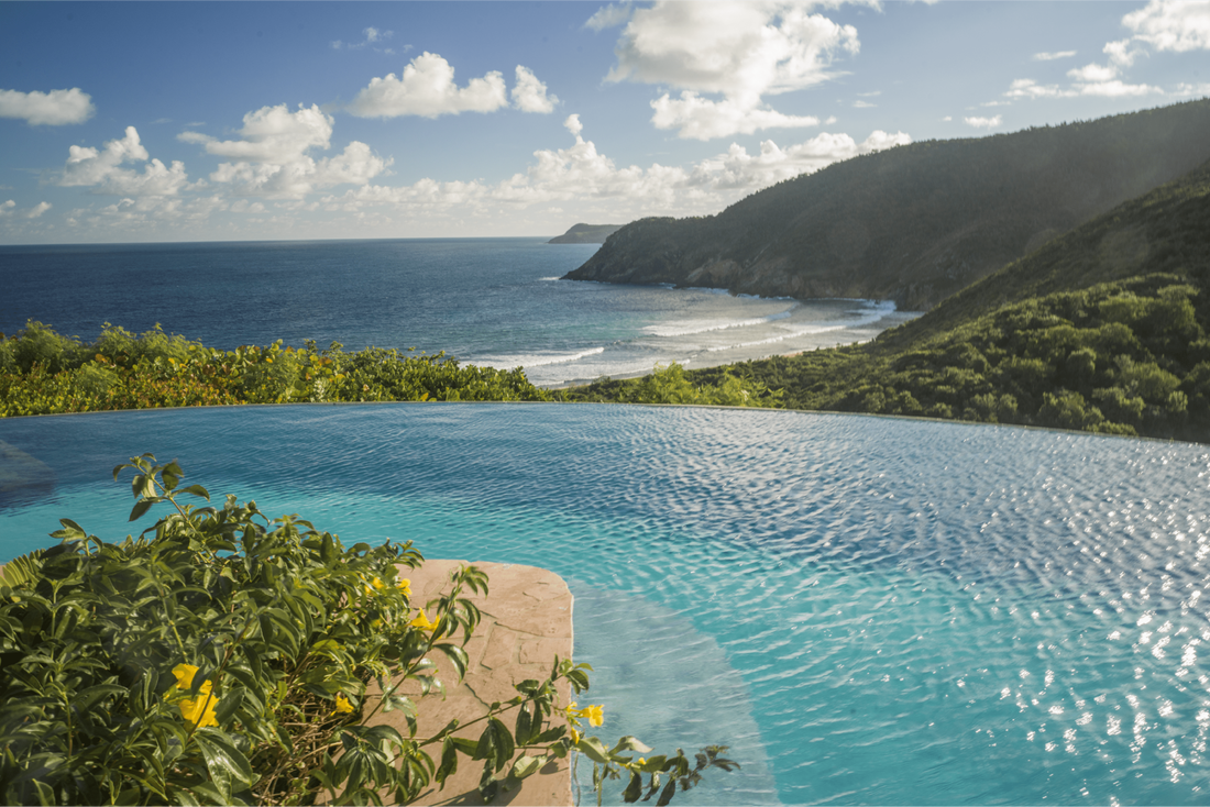 a pool overlooking the mountains and sea at Guana Island