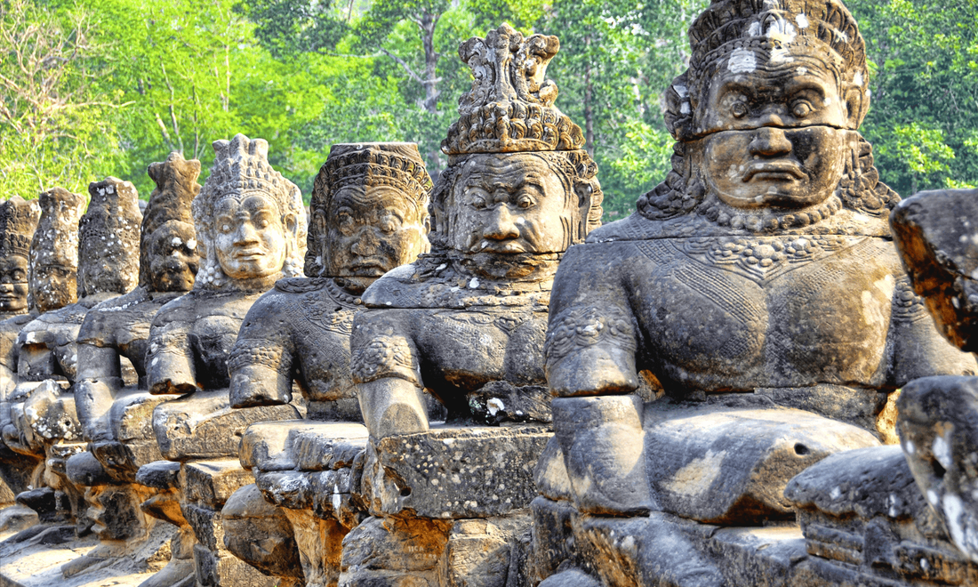 a number of stone statues in a jungle