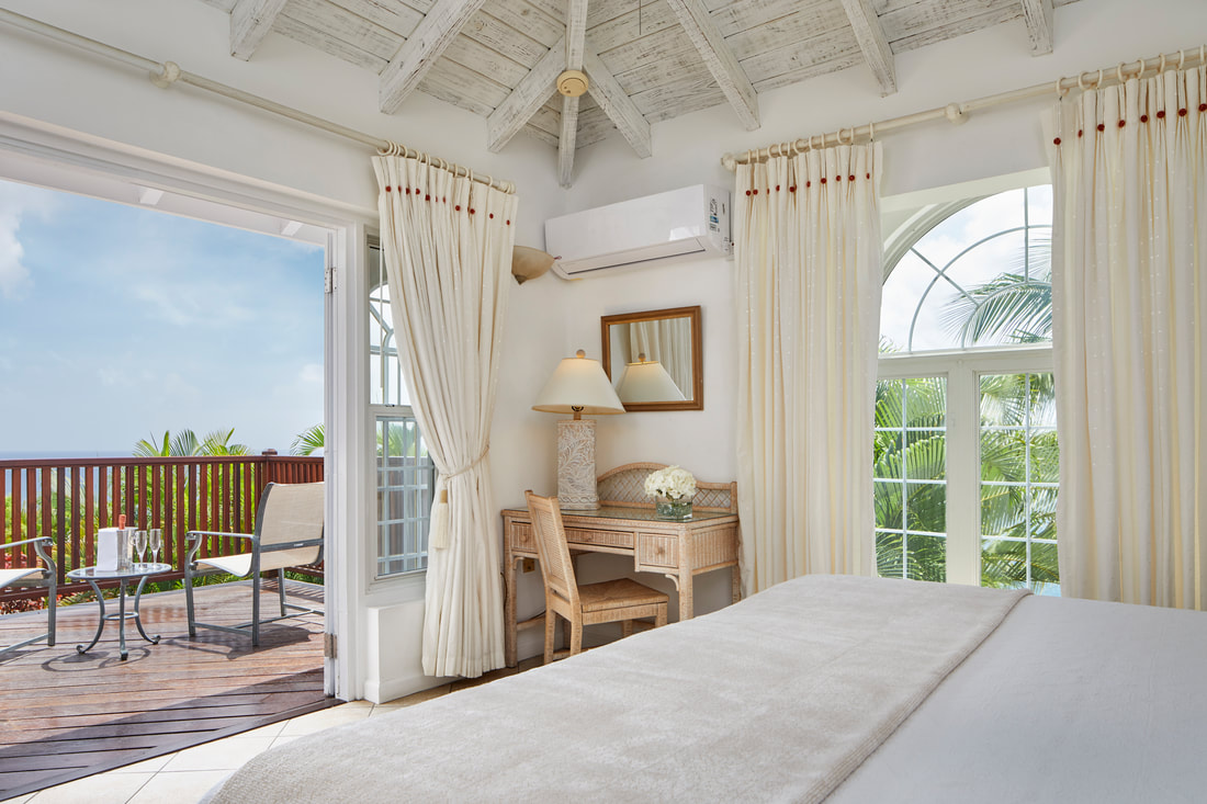 a bedroom and balcony at Windjammer Landing