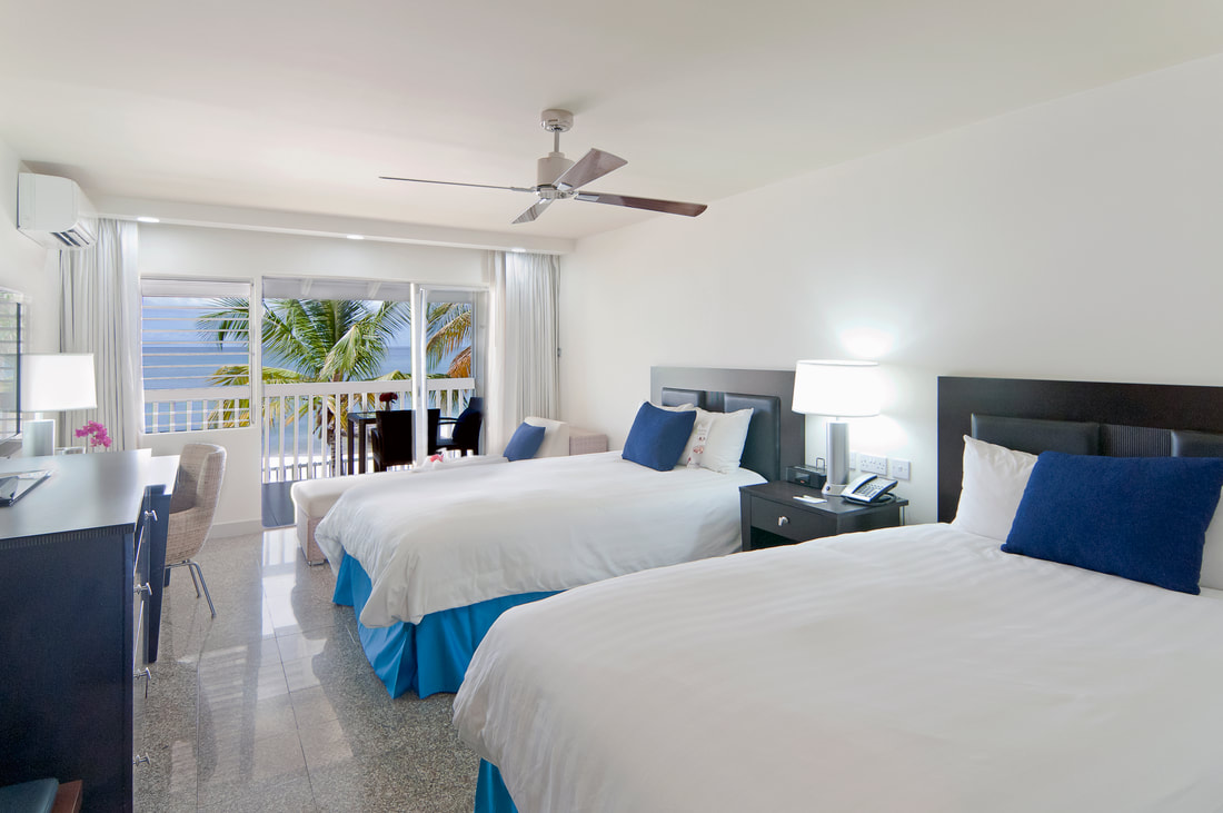 a Twin room with a balcony at the Radisson Grenada Beach