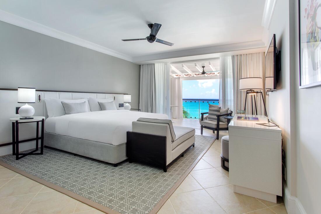a modern guest room with oceanfront balcony at fairmont royal pavilion
