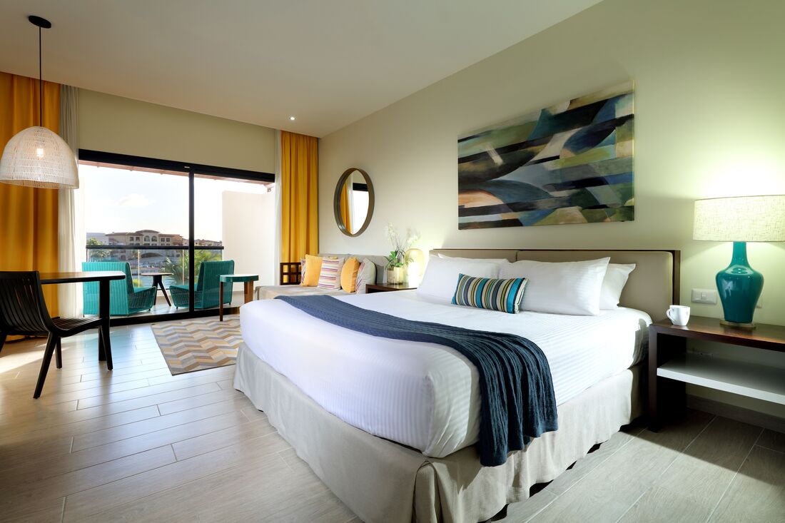 a double bedroom suite with balcony that overlooks the resort and pool
