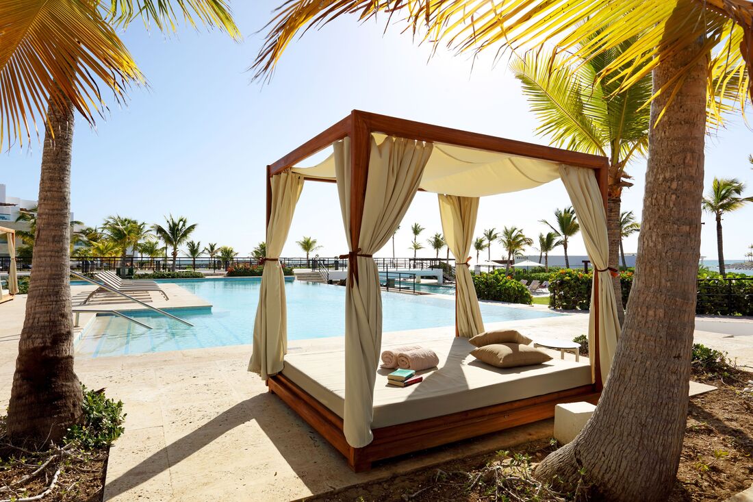 A double bed cabana next to the pool at TRS Cap Cana