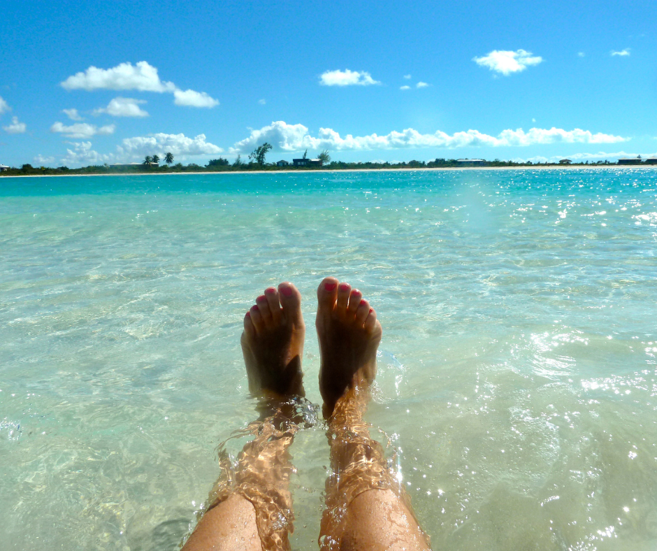 Someone with their feet in the water in Turks & Caicos